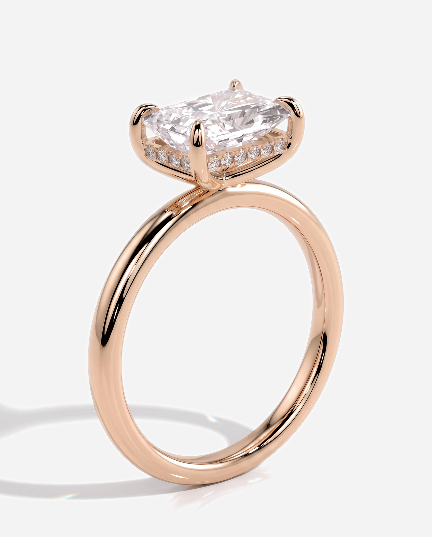 Tamsin Radiant East West Claw Solitaire with Hidden Halo Engagement Ring, lab grown diamond in rose gold, three quarter view