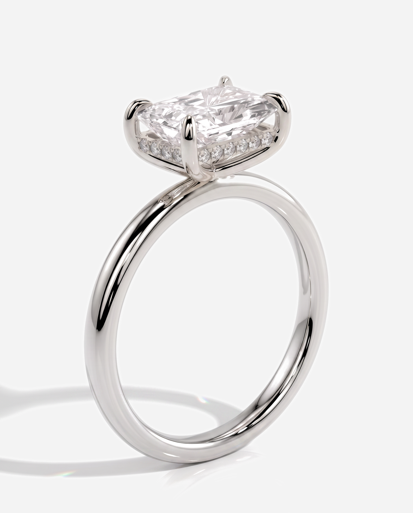 Tamsin Radiant East West Claw Solitaire with Hidden Halo Engagement Ring, lab grown diamond in platinum, three quarter view