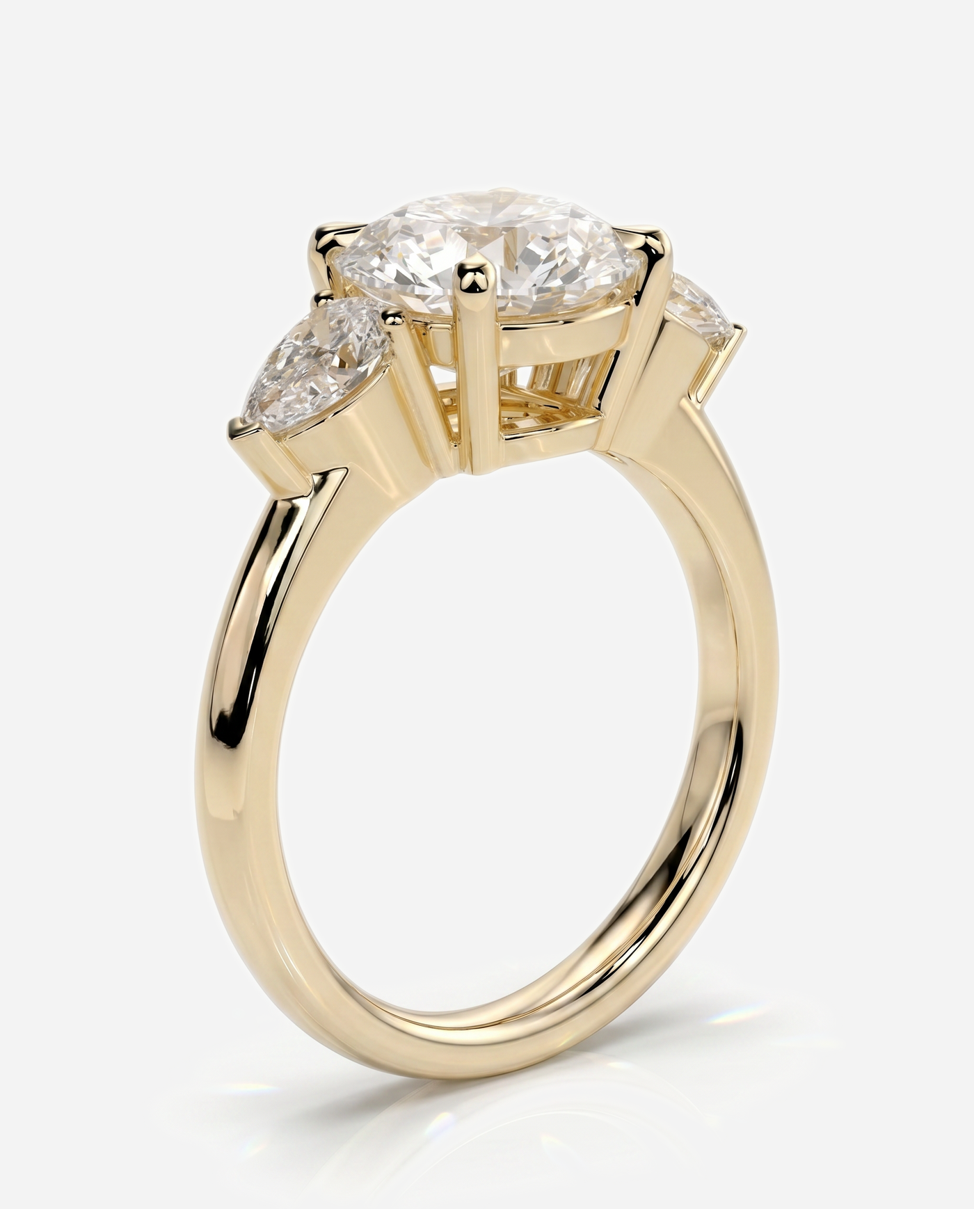 Alyssa Round Claw Trilogy with Pear Side Stones and Knife Edge Band Engagement Ring, lab grown diamond in yellow gold, three quarter view