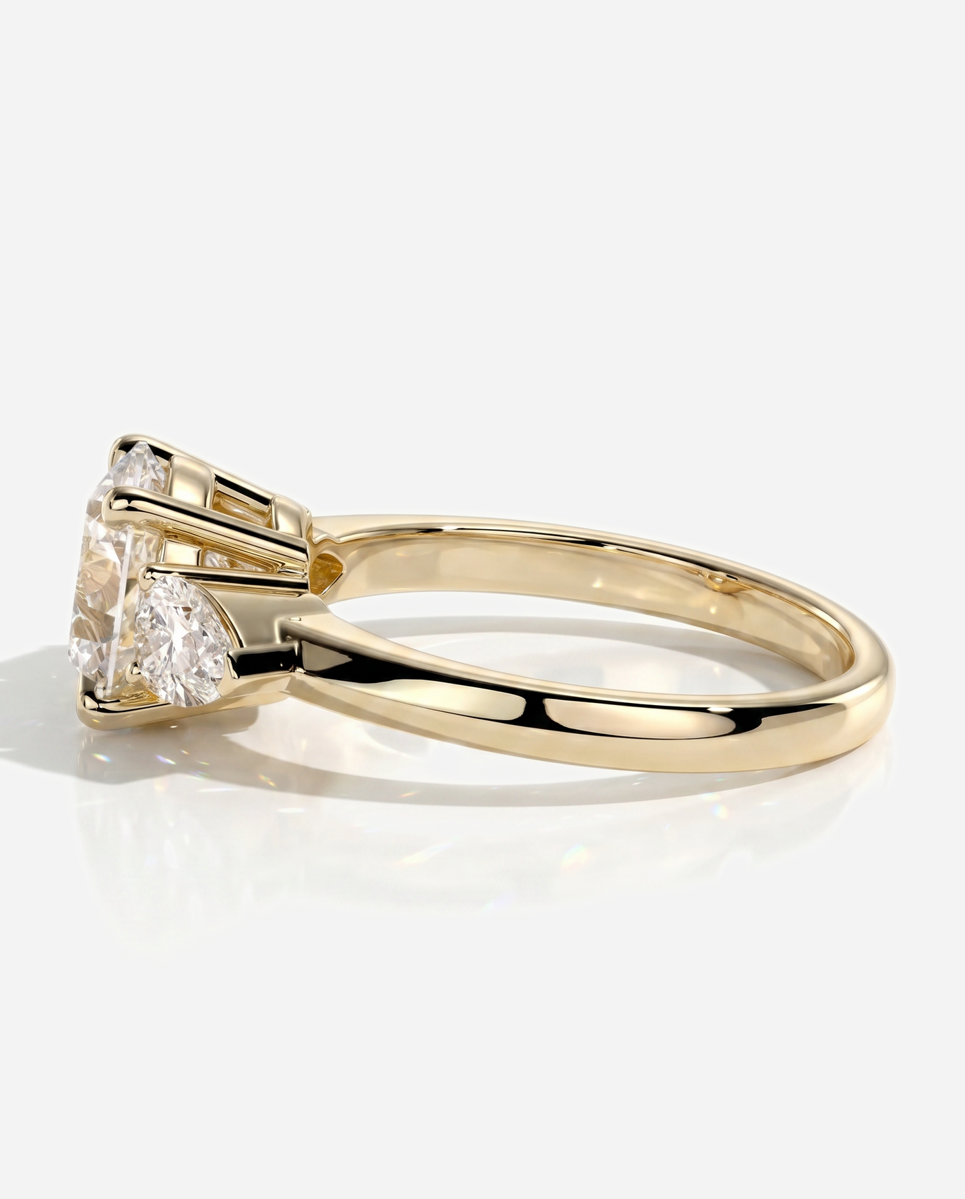 Alyssa Round Claw Trilogy with Pear Side Stones and Knife Edge Band Engagement Ring, lab grown diamond in yellow gold, detail view