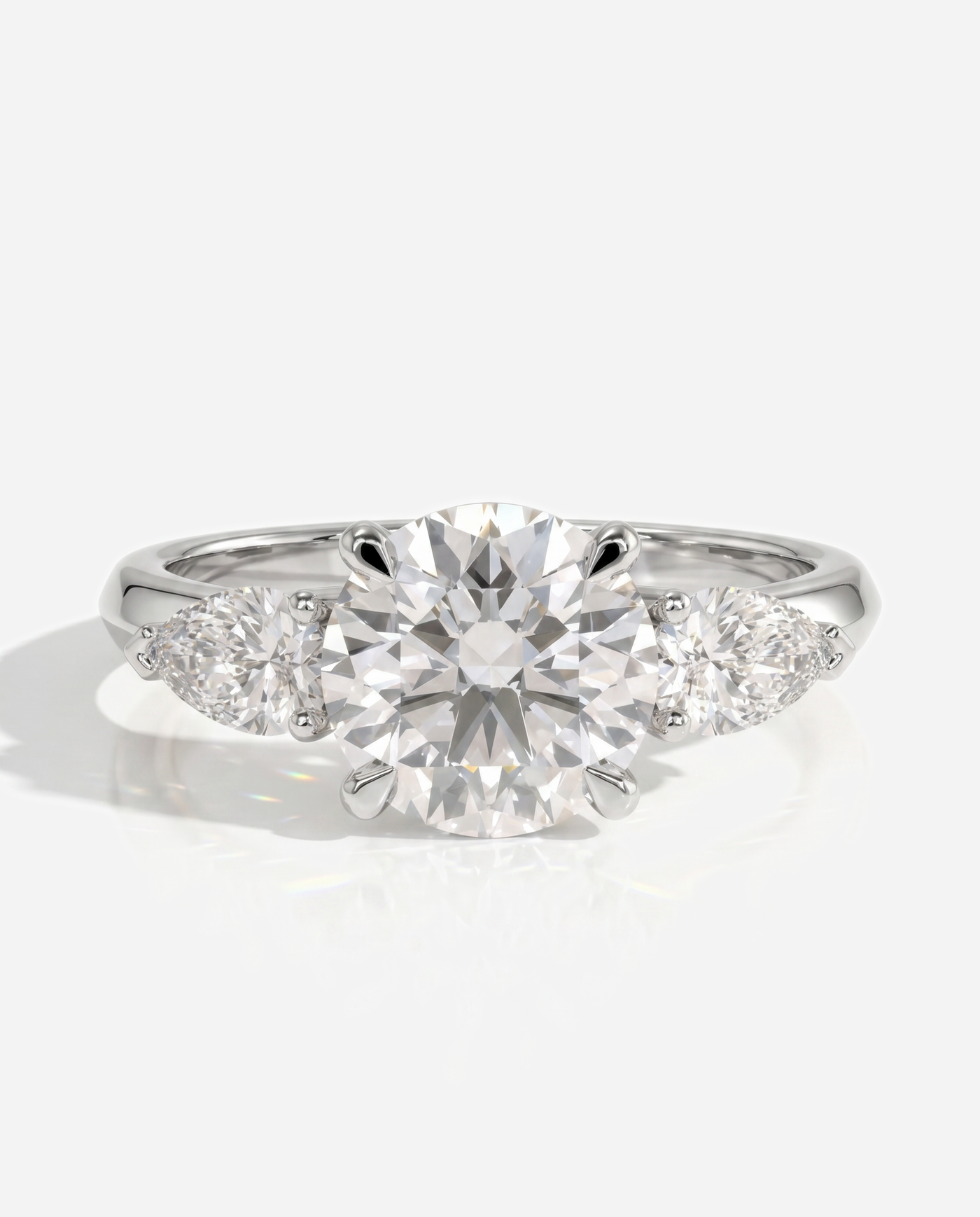 Alyssa Round Claw Trilogy with Pear Side Stones and Knife Edge Band Engagement Ring, lab grown diamond in platinum, front view