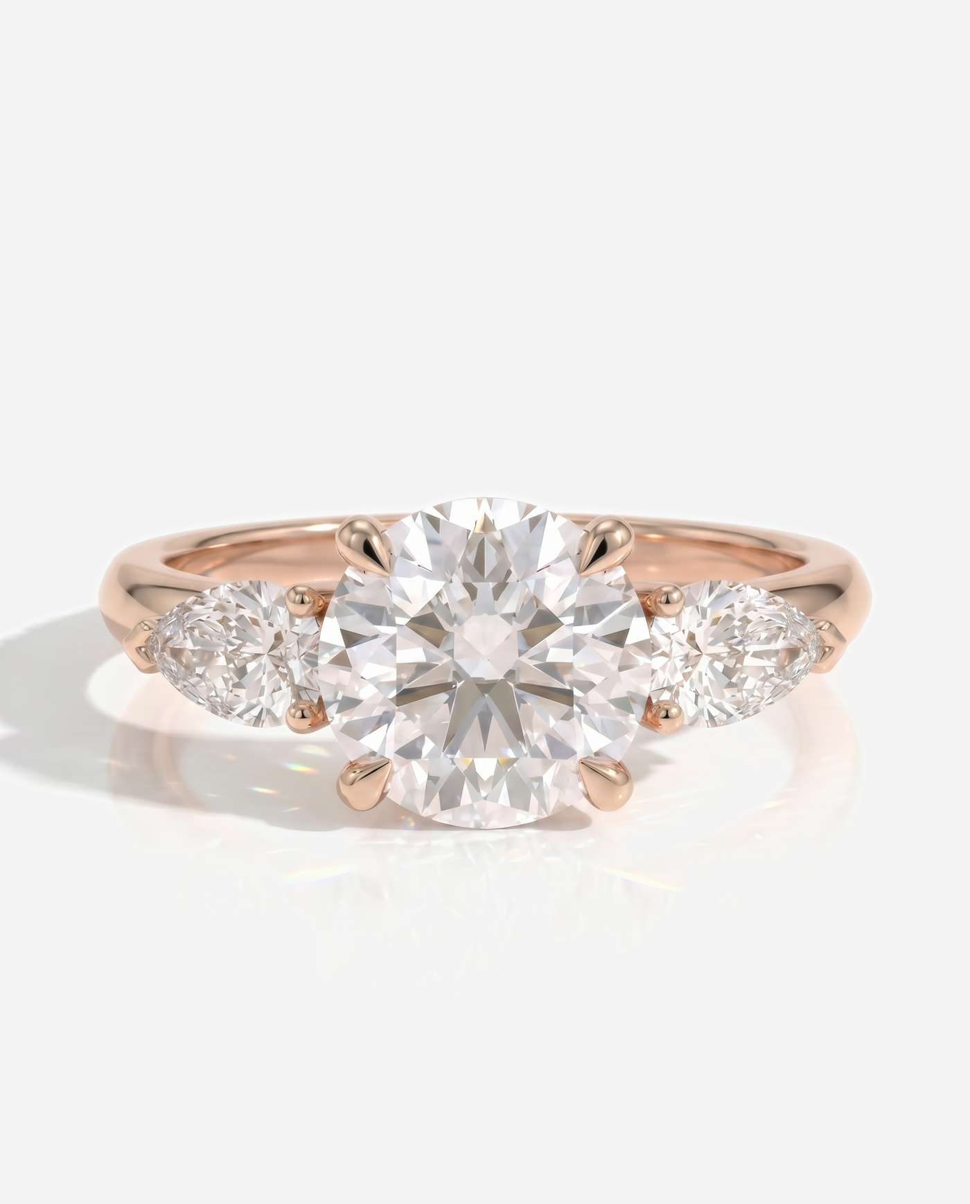 Alyssa Round Claw Trilogy with Pear Side Stones and Knife Edge Band Engagement Ring, lab grown diamond in rose gold, front view