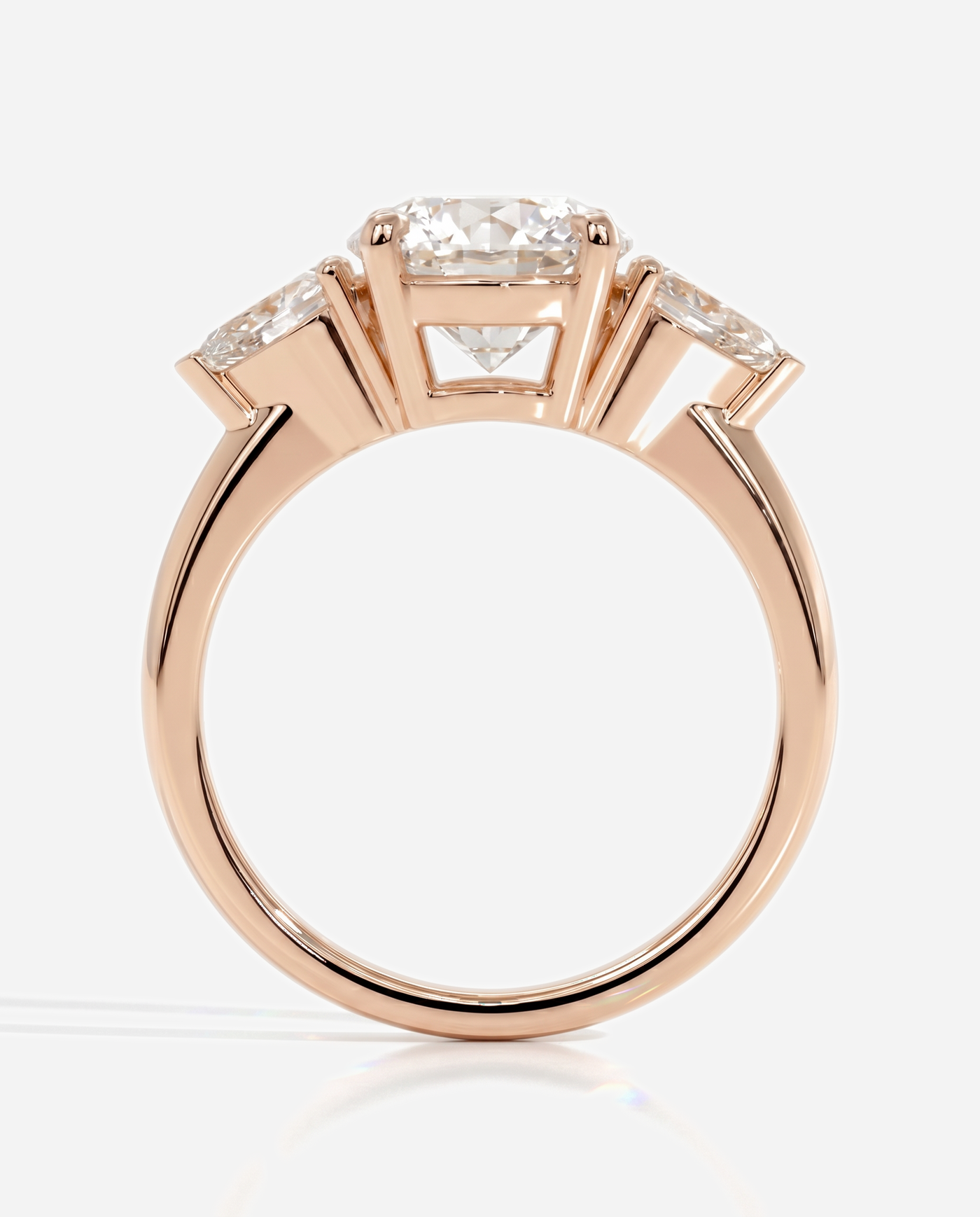 Alyssa Round Claw Trilogy with Pear Side Stones and Knife Edge Band Engagement Ring, lab grown diamond in rose gold, side profile