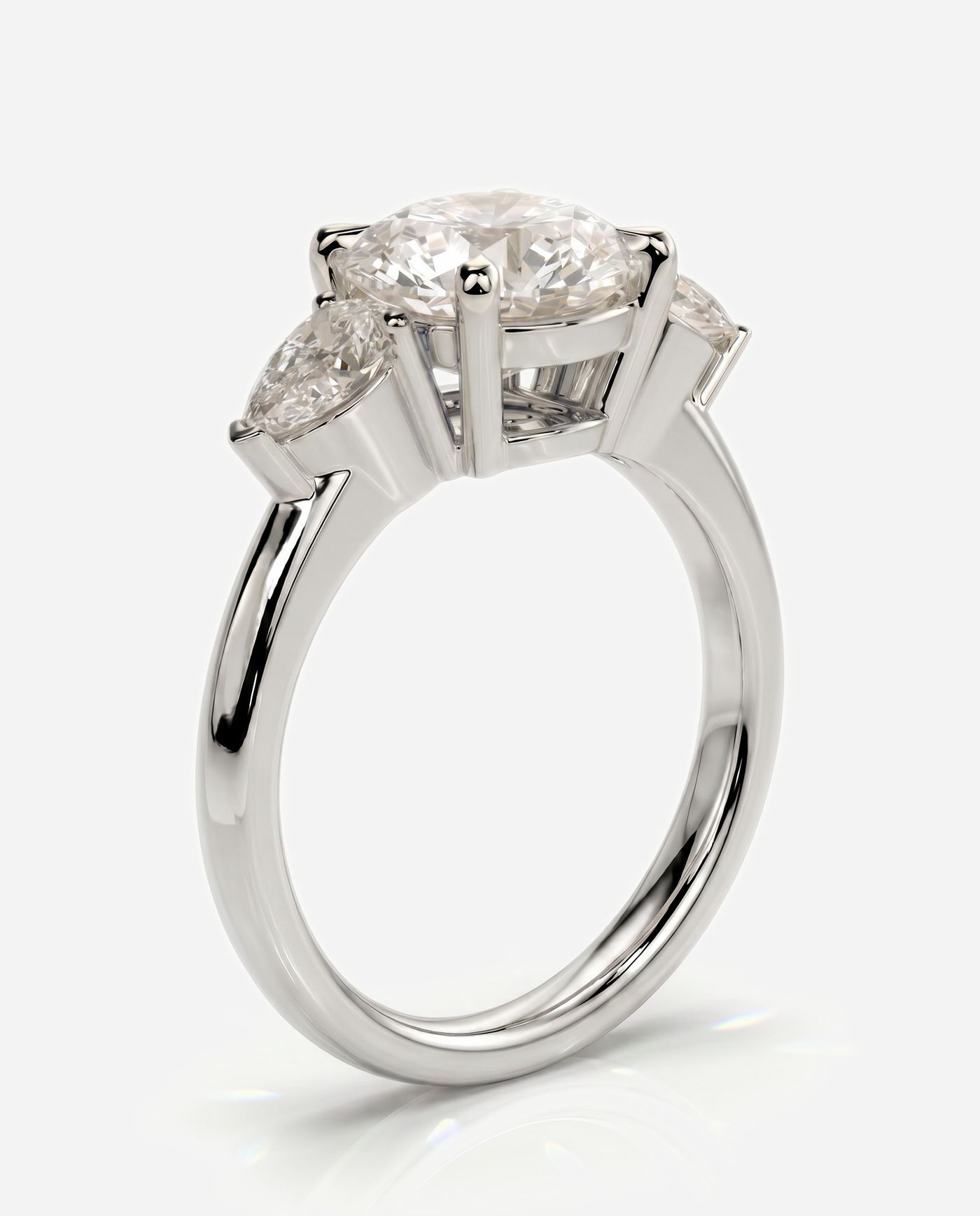 Alyssa Round Claw Trilogy with Pear Side Stones and Knife Edge Band Engagement Ring, lab grown diamond in white gold, three quarter view