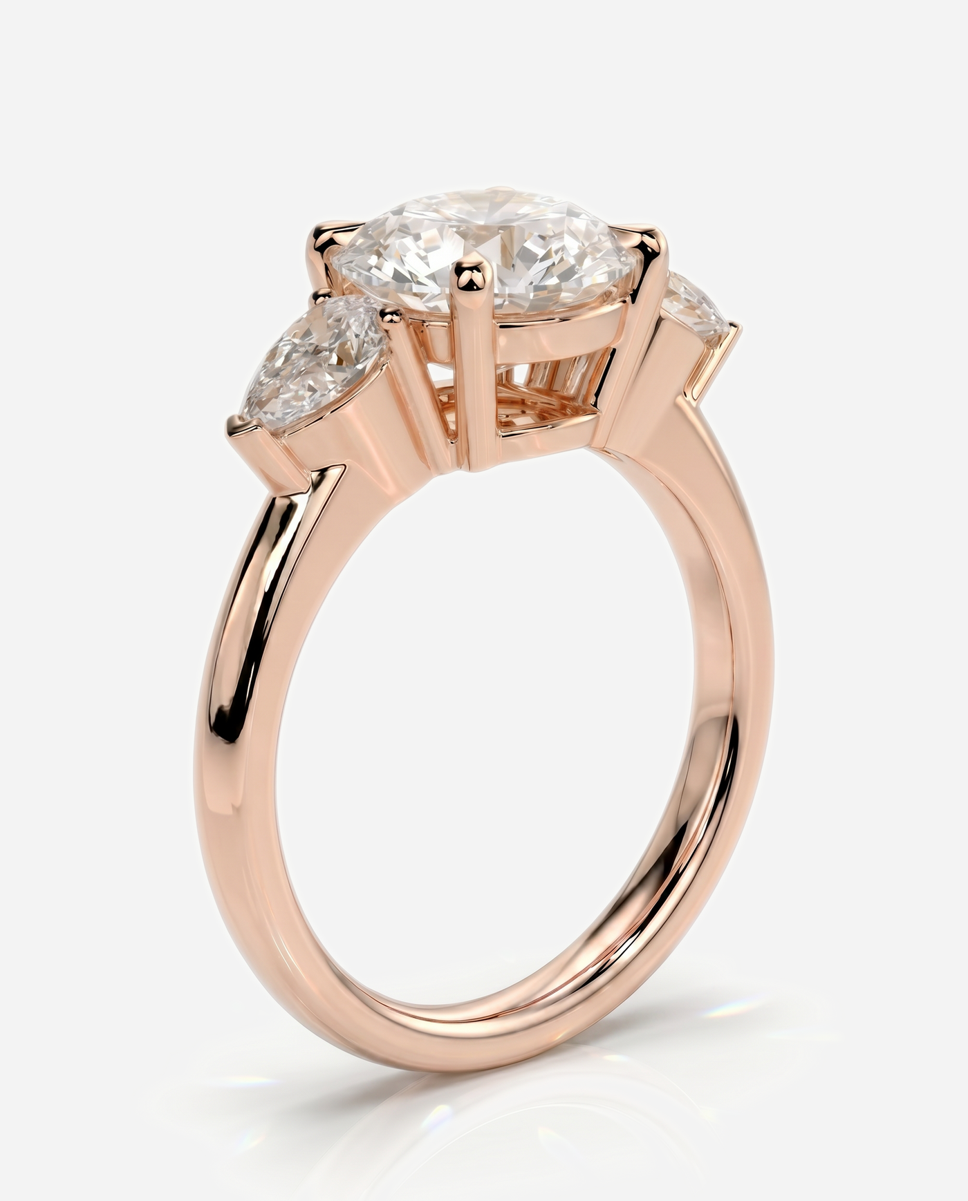 Alyssa Round Claw Trilogy with Pear Side Stones and Knife Edge Band Engagement Ring, lab grown diamond in rose gold, three quarter view