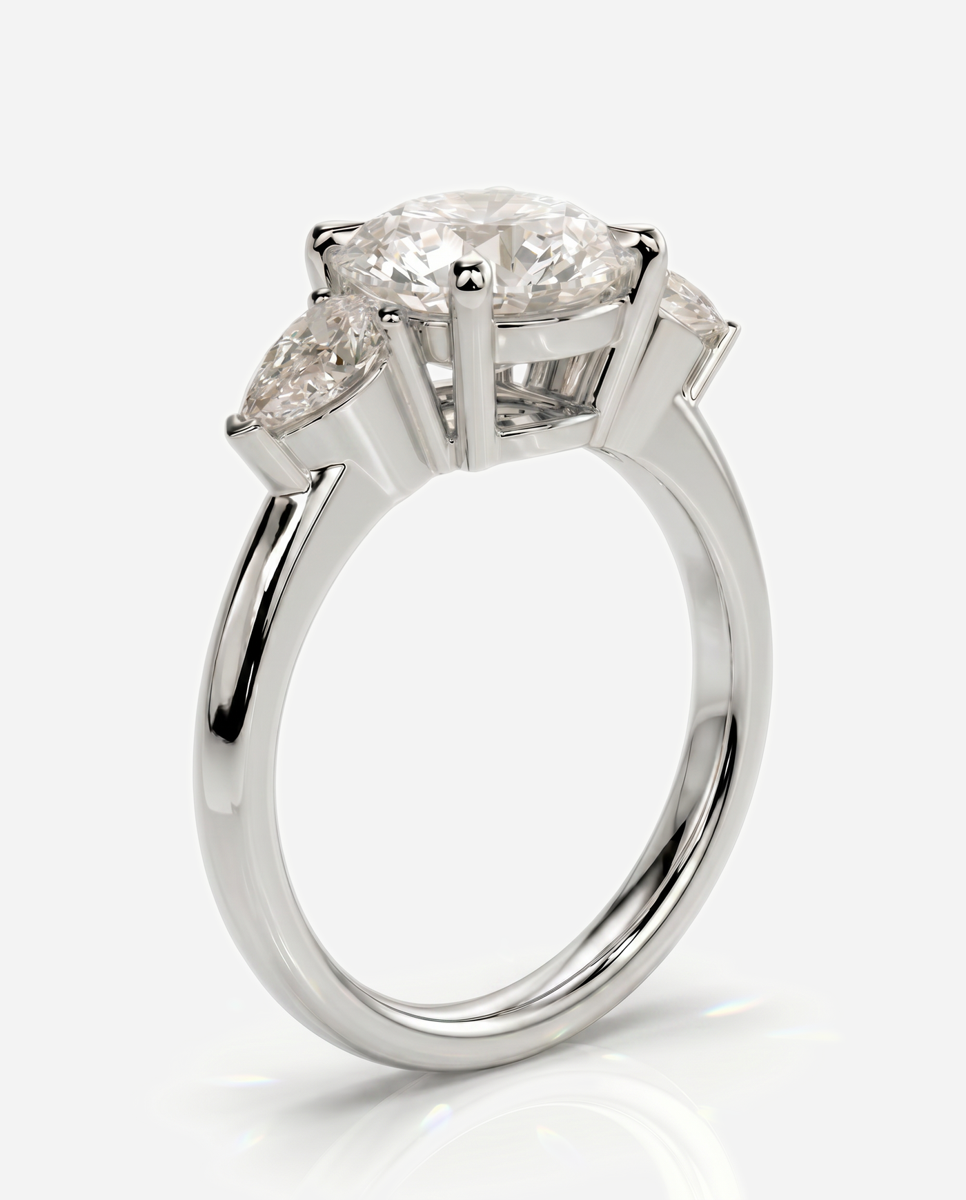 Alyssa Round Claw Trilogy with Pear Side Stones and Knife Edge Band Engagement Ring, lab grown diamond in platinum, three quarter view