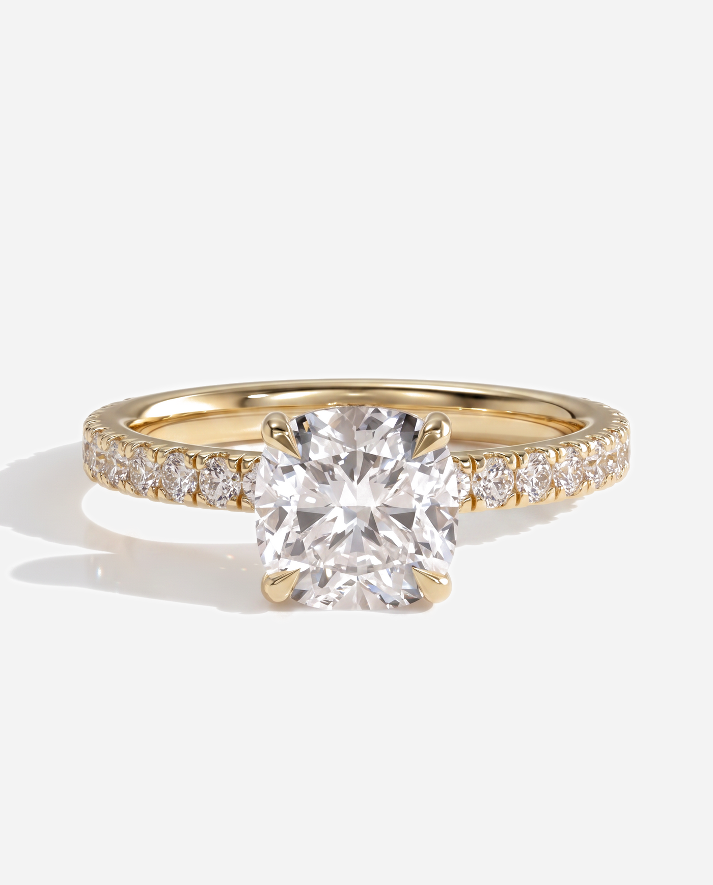 Cadence Cushion Claw Solitaire with Hidden Halo and Pave Band Engagement Ring, lab grown diamond in yellow gold, front view