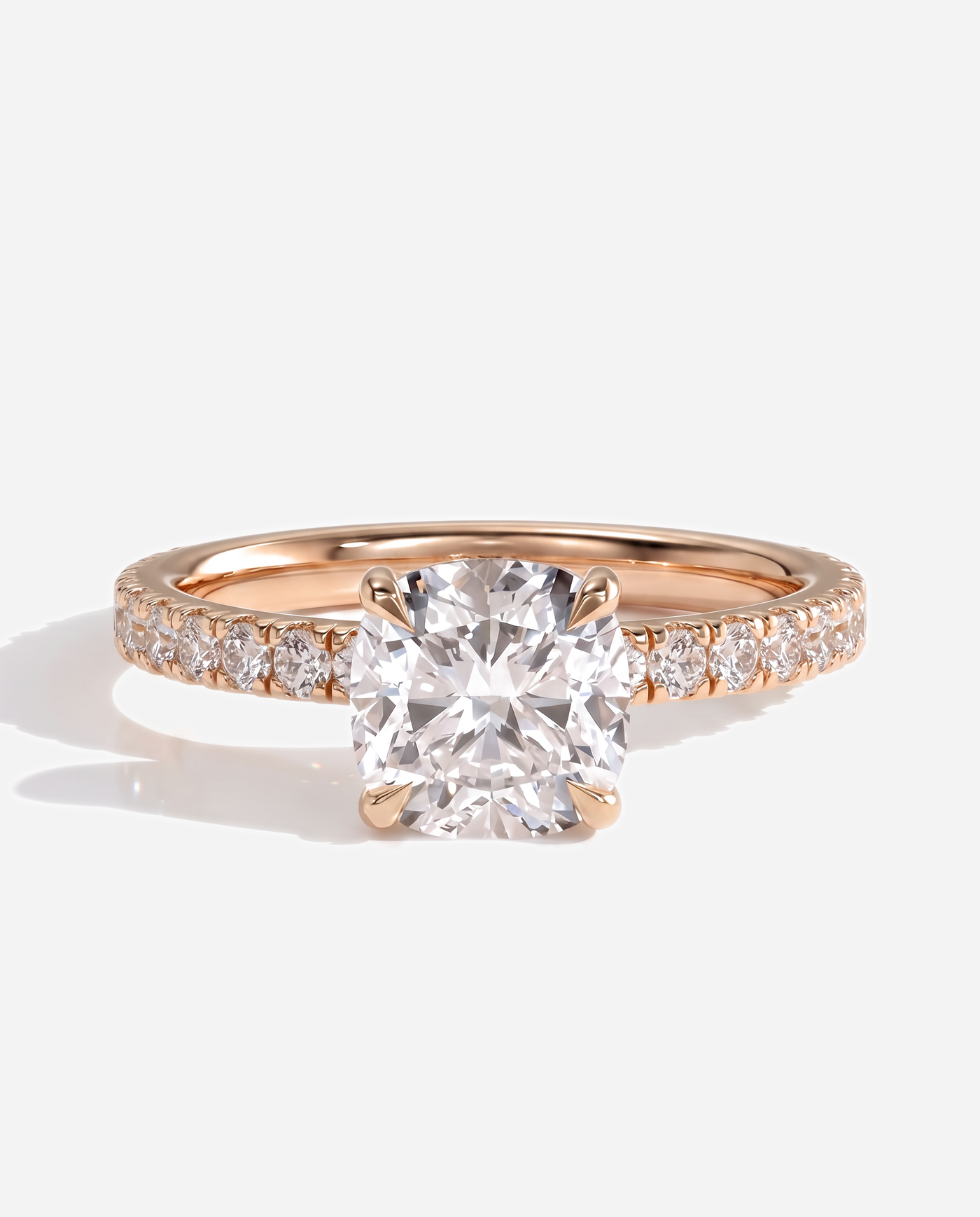 Cadence Cushion Claw Solitaire with Hidden Halo and Pave Band Engagement Ring, lab grown diamond in rose gold, front view