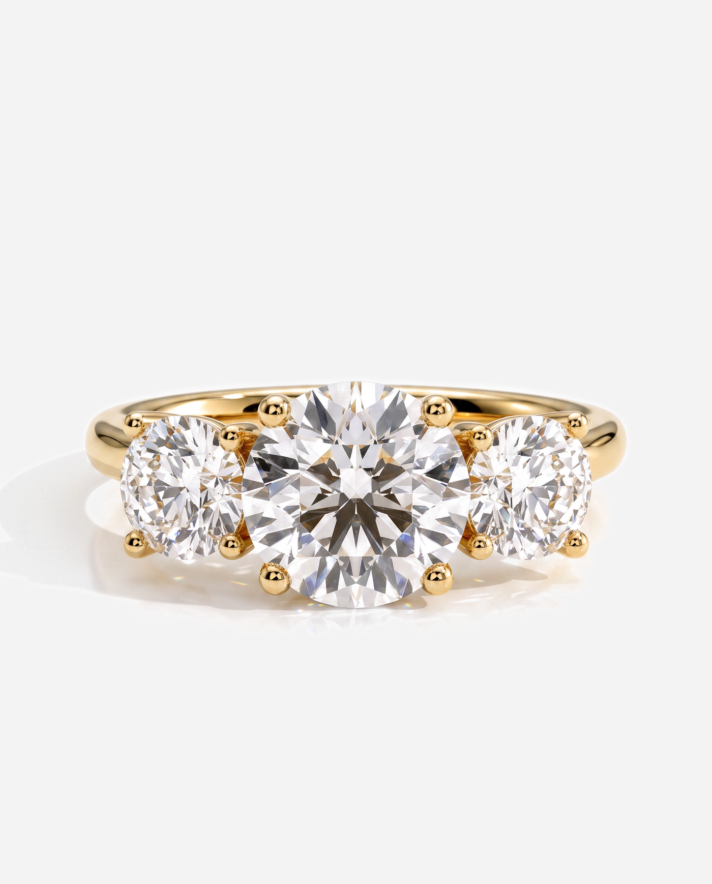 Teagan Round Claw Trilogy with Round Side Stones and Trellis Gallery Engagement Ring, lab grown diamond in yellow gold, front view