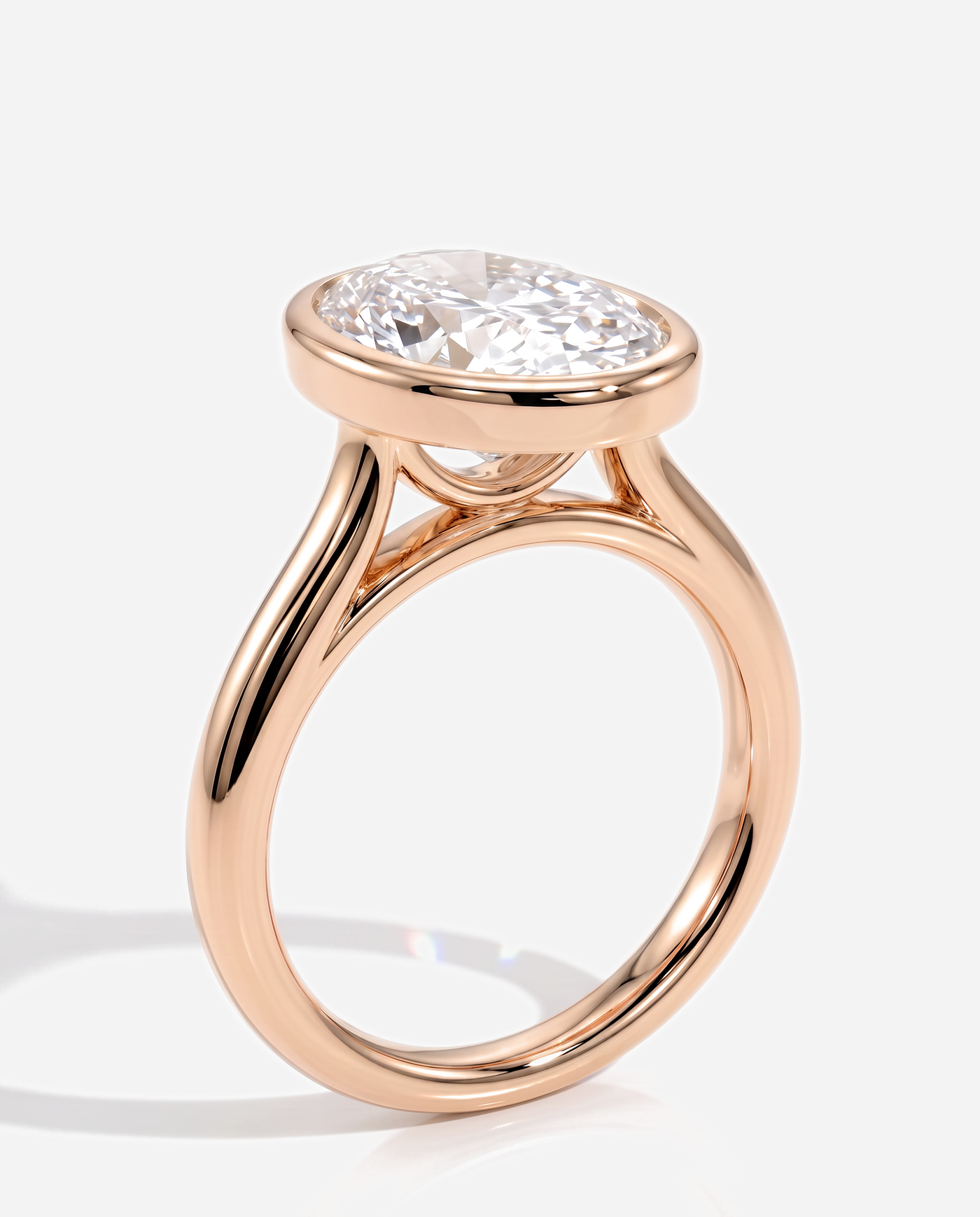 Vesper Oval Bezel Solitaire with Cathedral Setting Engagement Ring, lab grown diamond in rose gold, three quarter view