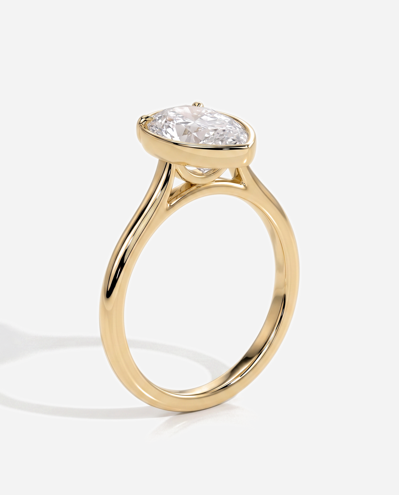 Tori Pear Bezel Solitaire with Cathedral Setting Engagement Ring, lab grown diamond in yellow gold, three quarter view